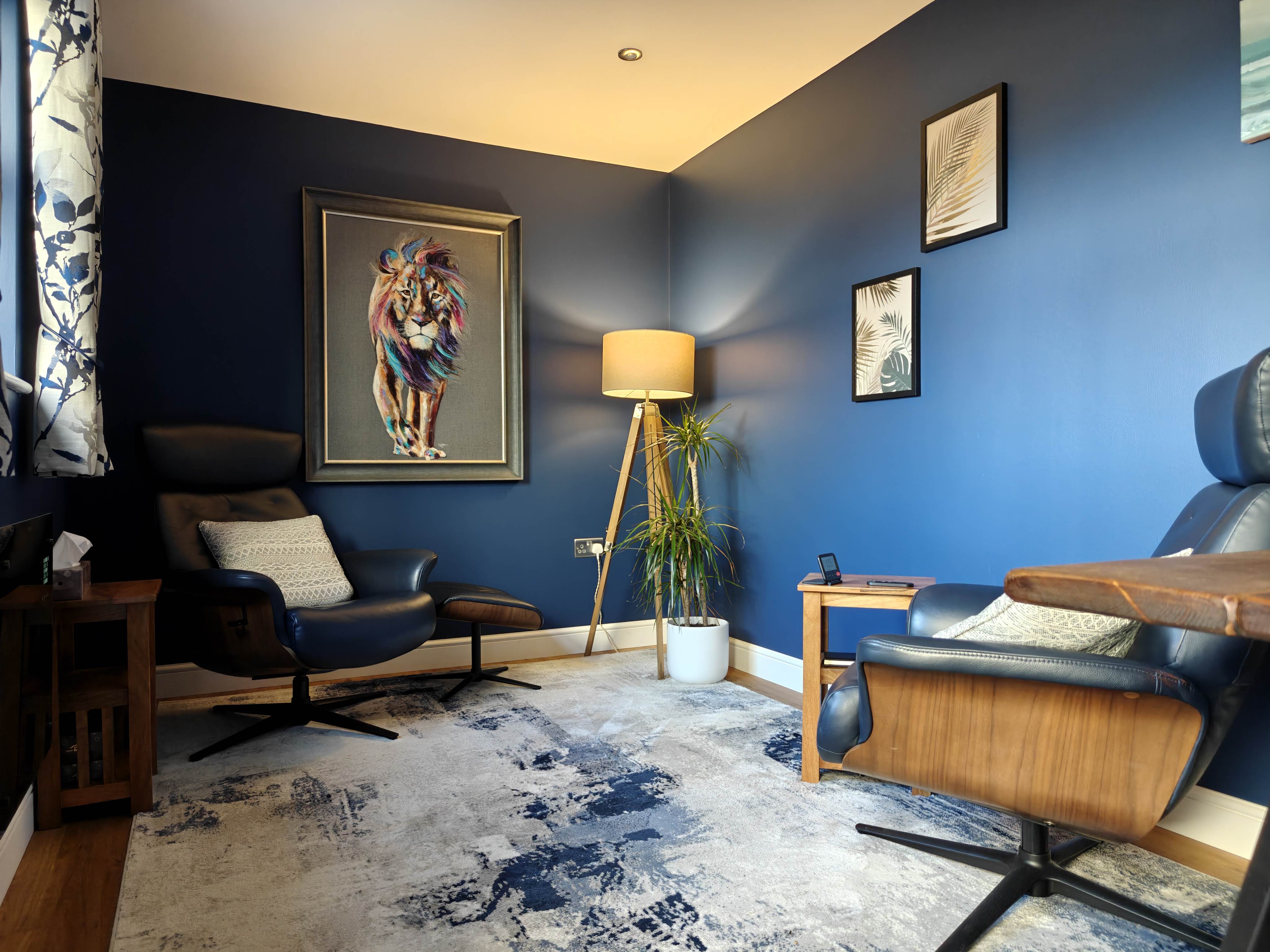 The therapy room in daylight, with comfortable chairs and warm natural light