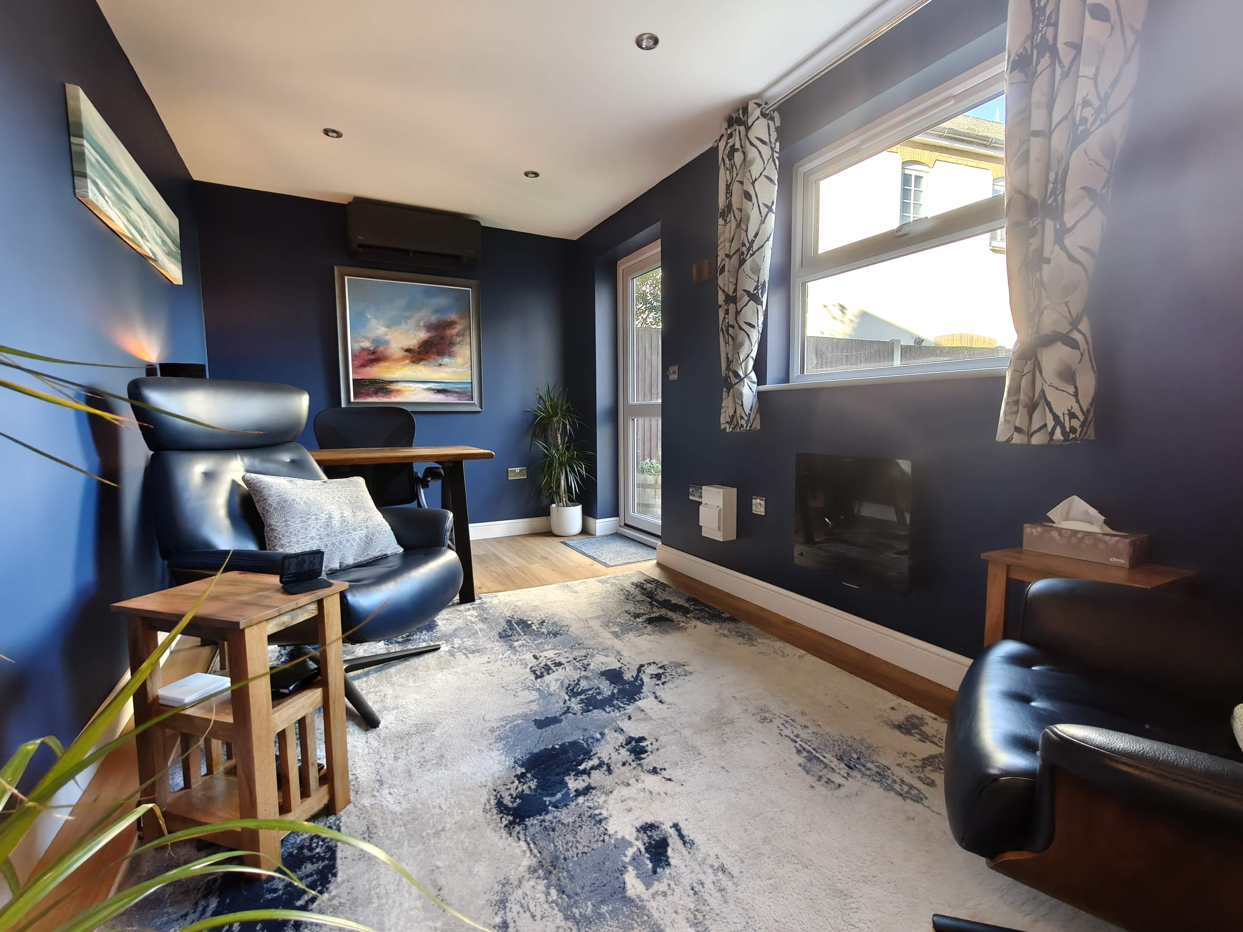 The therapy room with natural light from the window and garden door
